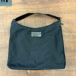 Versatile canvas black pre owned Kate Spade tote with polka dot interior